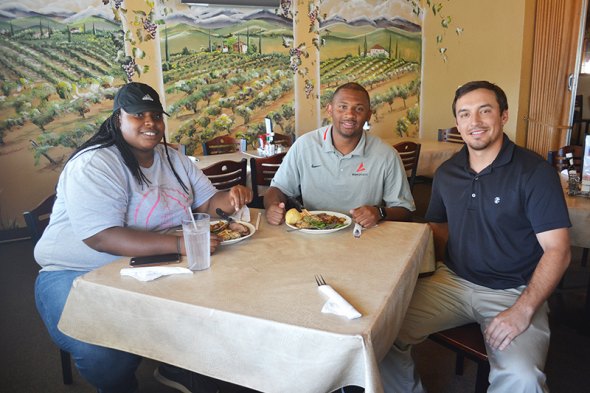 Demetrius Porter, "Exposure Sports" founder, samples the cuisine with Shatari Sykes (left) and Vineyard Restaurant Manager Joe Jones (right).